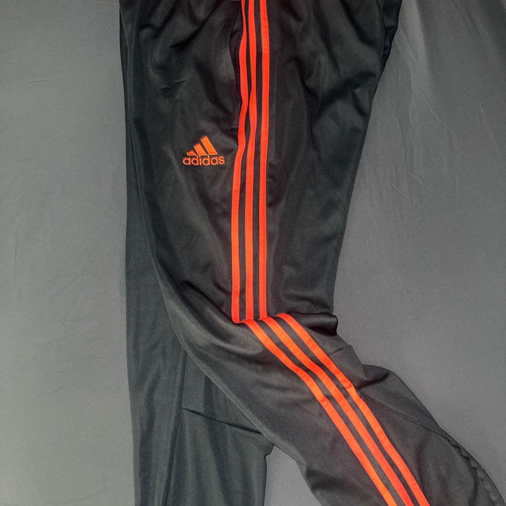 Adidas Black and Orange Track Pants with Signature Stripes